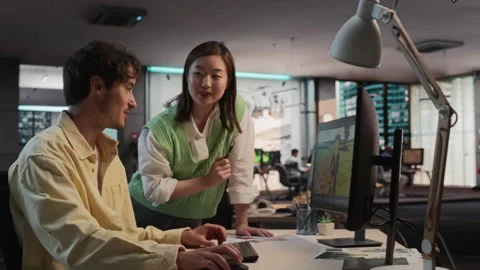 Diverse Colleagues Using PC In Game Development Office Stock Footage 255795192
