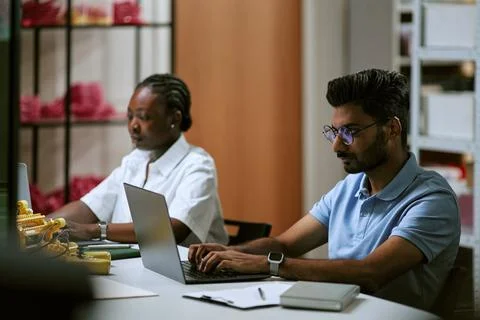 Diverse Colleagues Working on Laptops in Tech Workshop Office Stock Photos