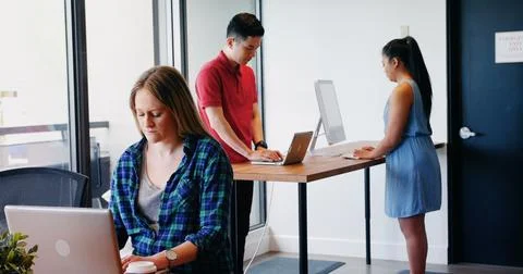 Diverse colleagues working in office, using computers 스톡 사진