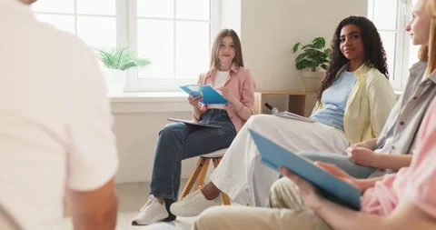 Diverse college students in circle during classroom discussion teamwork seminar Stock Footage 340867753