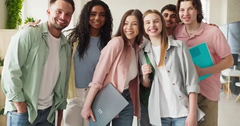 Diverse college students smiling in classroom, friendly group portrait indoors Stock Footage 345924635