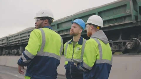 Diverse construction workers or industrial inspectors discuss earthwork at Stock Footage 124305841