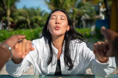 Diverse content creator couple vlogging or streaming from a scenic tropical.. Fotos de archivo