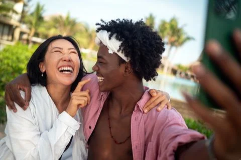 Diverse content creator couple vlogging or streaming from a scenic tropical.. Fotos de archivo