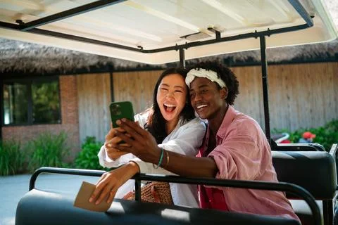 Diverse content creator couple vlogging or streaming from a scenic tropical.. Fotos de archivo