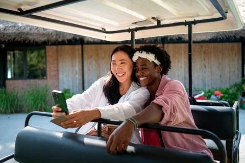 Diverse content creator couple vlogging or streaming from a scenic tropical.. Fotos de archivo