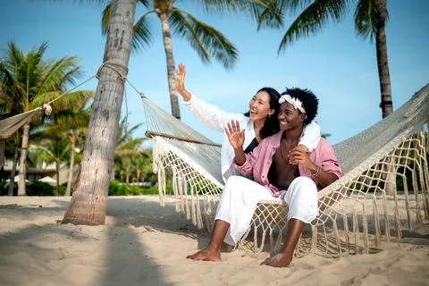 Diverse content creator couple vlogging or streaming from a scenic tropical.. Fotos de archivo