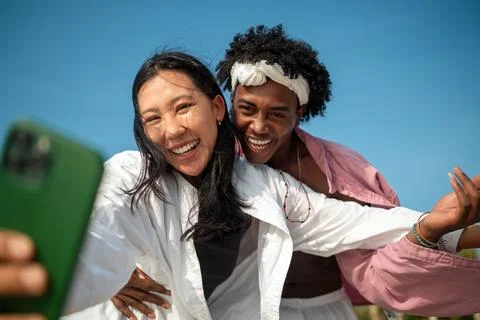 Diverse content creator couple vlogging or streaming from a scenic tropical.. Stock Photos