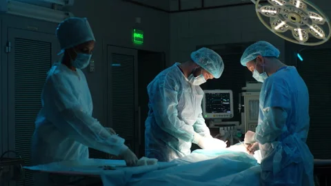 Diverse cooperating team of doctors and surgeons processing surgical operation Stock Footage 262029879