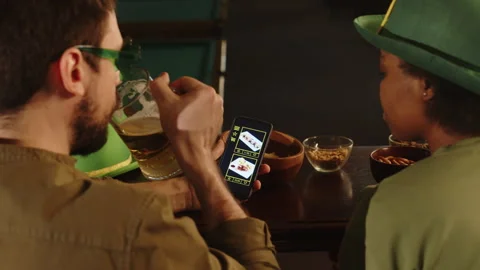Diverse Couple Choosing Meals on Menu at Bar Counter on St Patricks Day Stock Footage 290454610