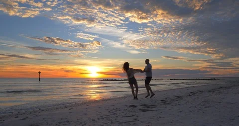 Diverse Couple Dancing on Beach at Sunset, Slow Motion Stock Footage 105828158