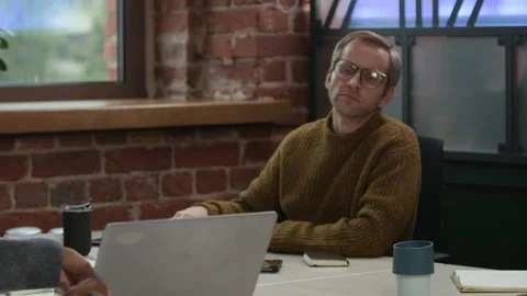 Diverse Couple of Developers Discussing Program Coding on Laptop in Office Stock Footage 319997310