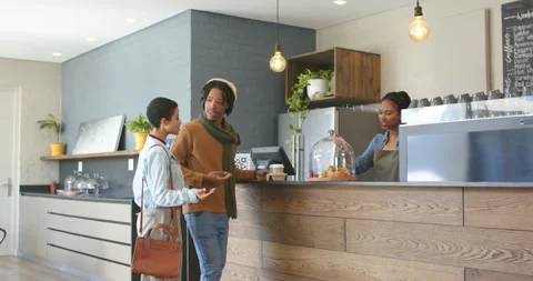 Diverse couple entering cafe, pointing at pastries, ordering to-go coffees, Vídeo Stock 342392297