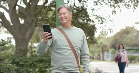 Diverse couple, man mounting e-scooter reading smartphone map on sidewalk while Vídeo Stock 344339617