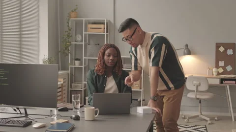 Diverse Couple of Programmers Coworking on Office Stock Footage 195977662
