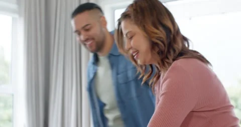 Diverse couple sharing hug and sitting at table preparing noodle bowls with Stock Footage 335513931