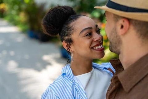 Diverse couple sharing a laugh while exploring a tropical paradise together.. Stock Photos