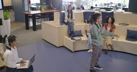 Diverse coworkers clapping at office, nonbinary presenter rising, walking Stock Footage 343887472