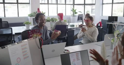 Diverse coworkers clapping while Asian man producing festive gift, presenting to Stock Footage 344404768