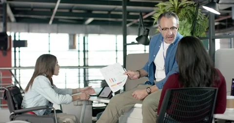 Diverse coworkers comparing tablet and charts as White man presenting to Stock Footage 317718752
