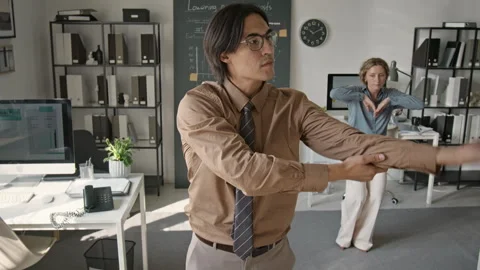 Diverse Coworkers Dancing Expressively during Office Break Stock Footage 345245662