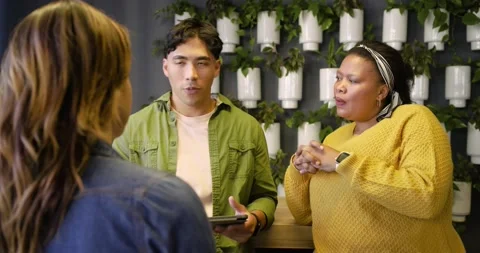 Diverse coworkers questioning presenter explaining tablet and interpreter 스톡 동영상 340972442