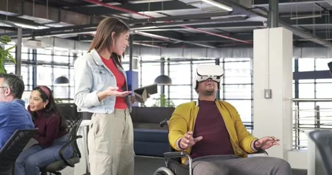 Diverse coworkers tapping tablet exploring VR with headset and switching phone Stock Footage 337624025