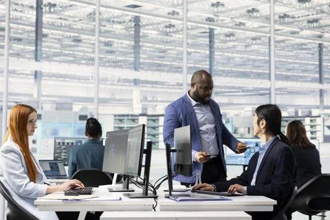 Diverse coworkers using artificial intelligence to do semiconductors prototyping Stock Photos