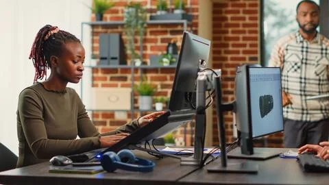 Diverse coworkers working on software development on multi monitors Stock Photos
