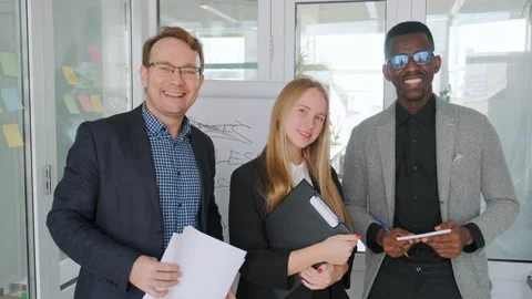 Diverse creative group standing in office and looking in camera with smile Stock Footage 188310031