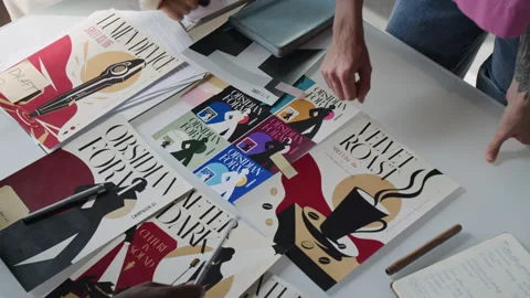 Diverse Creative Team Reviewing Graphic Design Posters in Office Stock Footage 345816785