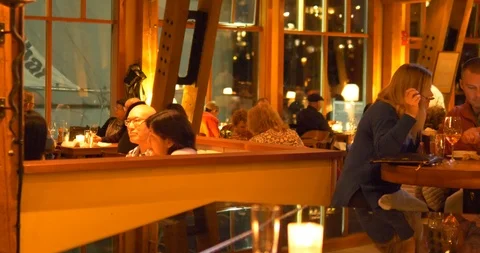 Diverse crowd dining at well lit restaurant Video stock 121768984