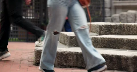 Diverse crowd passing plaza steps sneaker foot entering urging cyclist seated Stock Footage 341665293