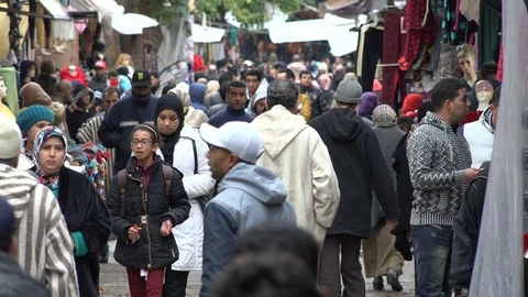 Diverse crowd of people walk through shopping alley in Fez, Morocco Stock Footage 71501176