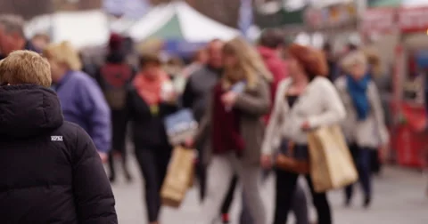 Diverse crowd of people walking through outdoor shopping market in a busy city Stock Footage 48128238