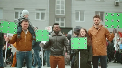 Diverse crowd of protesting people at rally with greenscreen mockup banners. Video stock 170012267