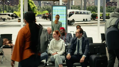 Diverse crowd in regional bus terminal checking departure time information Stock Footage 334727302