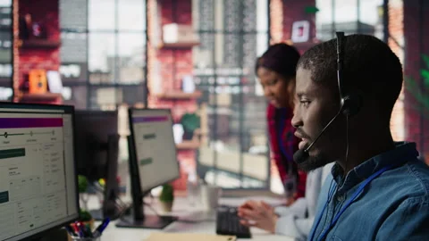 Diverse customer center workers assisting clients with installing software Stock Footage 305395474