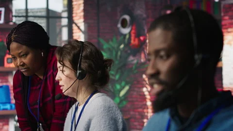 Diverse customer center workers assisting clients with installing software Stock Footage 305400962