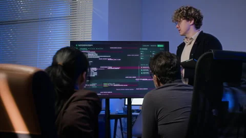 Diverse Cybersecurity Analysts Reacting to System Hacked Alert Stock Footage 347311331