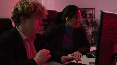 Diverse Cybersecurity Analysts Responding to System Breach in Office Stock Footage 347293732