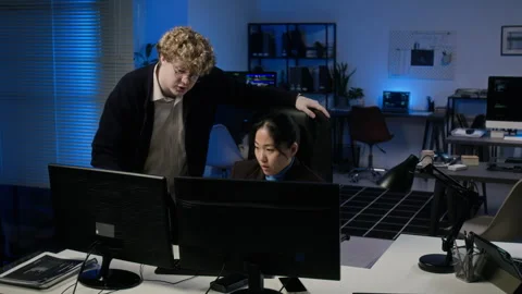 Diverse Cybersecurity Analysts Working on Computers in Office Stock Footage 347298622