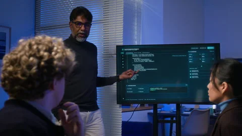 Diverse Cybersecurity Team Reviewing Code on Office Monitor Stock Footage 347317307