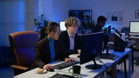 Diverse Cybersecurity Team Working on Computers in Night Office Stock Footage 347299399