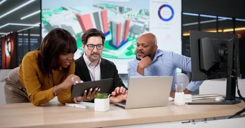 Diverse Design Team Using GIS Software Maps Urban Land For Construction. Youn Stock Photos