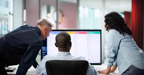 Diverse Development Team Collaborating On Kanban Board In Office Space. Stock Photos