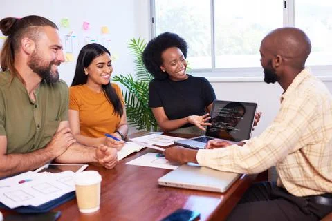 Diverse development team discusses code during code review meeting, programming Stock Photos