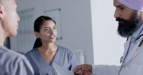 Diverse doctors and nurses talking in corridor at hospital, in slow motion Stock Footage 339320225