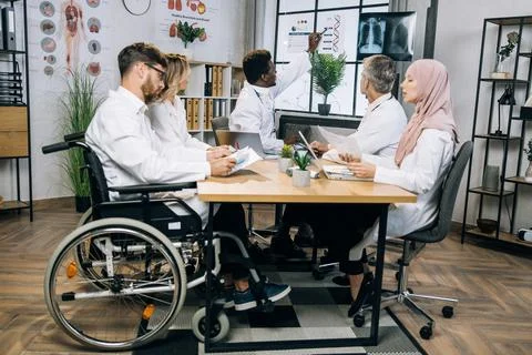 Diverse doctors talking about progress in medicine at office 스톡 사진