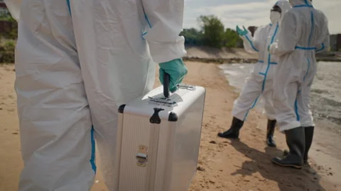 Diverse Ecologists in Hazmat Suits Inspecting Toxic Water Pollution Stock Footage 344717356
